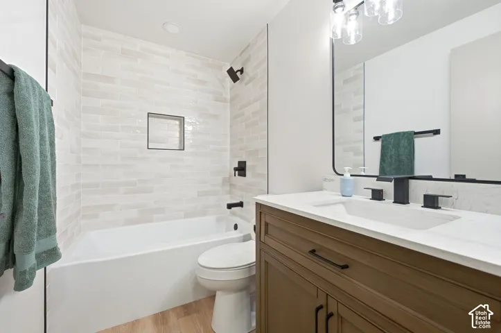 Modern bathroom featuring a wood-finish vanity with a white countertop and rectangular undermount sink