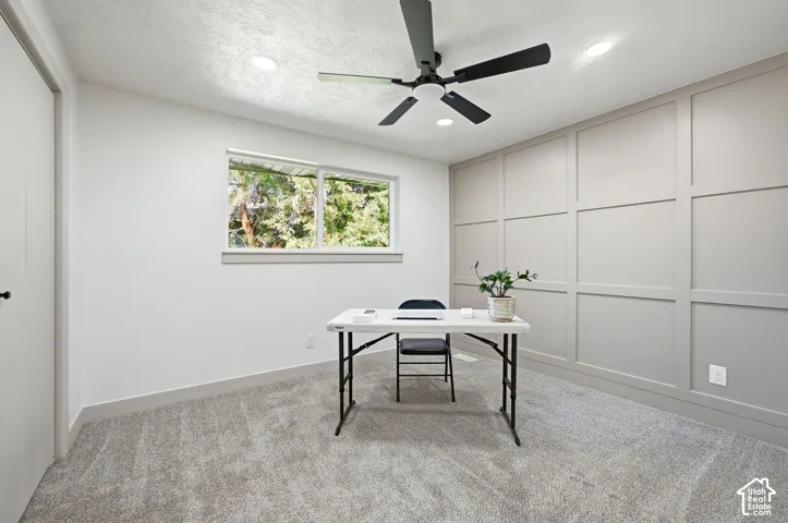 Wall paneling accent, recessed lighting, ceiling fan, carpeting, natural light