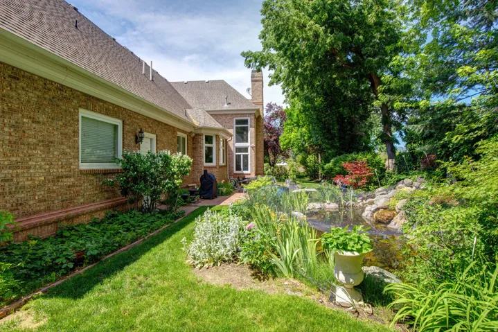 Brick exterior with a gabled roofline, bay window, and a stone chimney