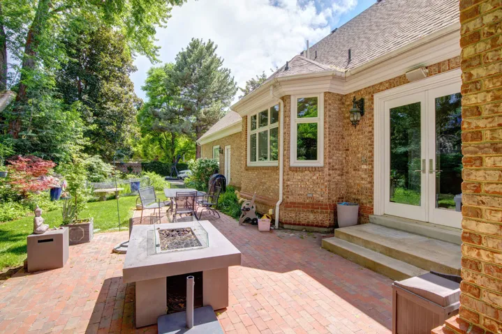 Brick exterior with white trim, multi-pane windows, and double glass doors