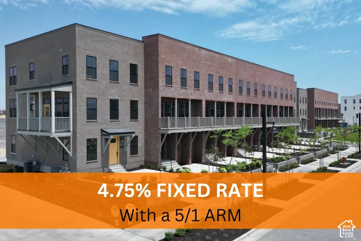 Multi-story brick exterior featuring recessed private balconies, dark-framed windows, and concrete ground-level patios