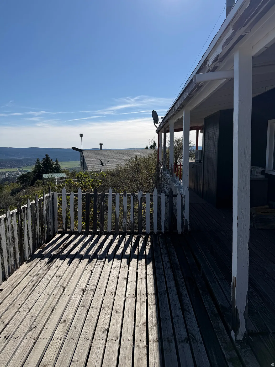 Exterior decking with picket railing and a covered porch