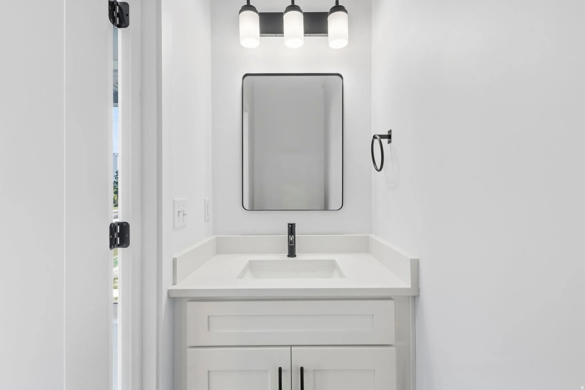 White shaker-style vanity with an integrated sink and light-toned countertop
