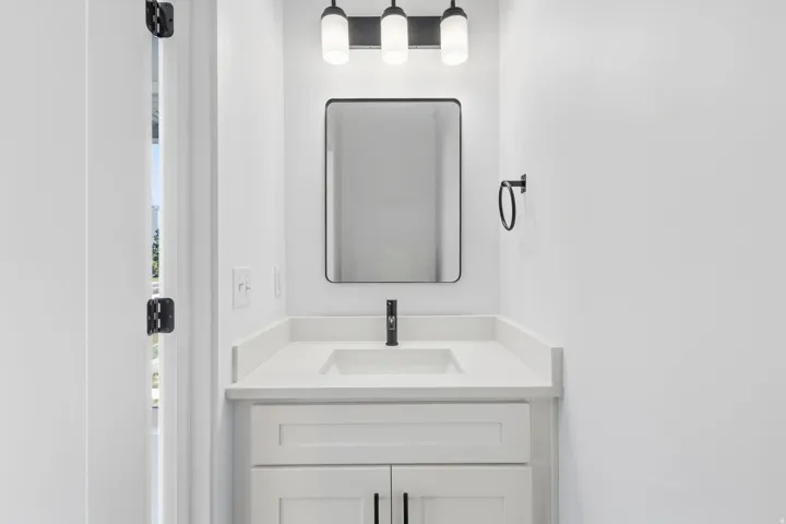 White shaker-style vanity with an integrated sink and light-toned countertop