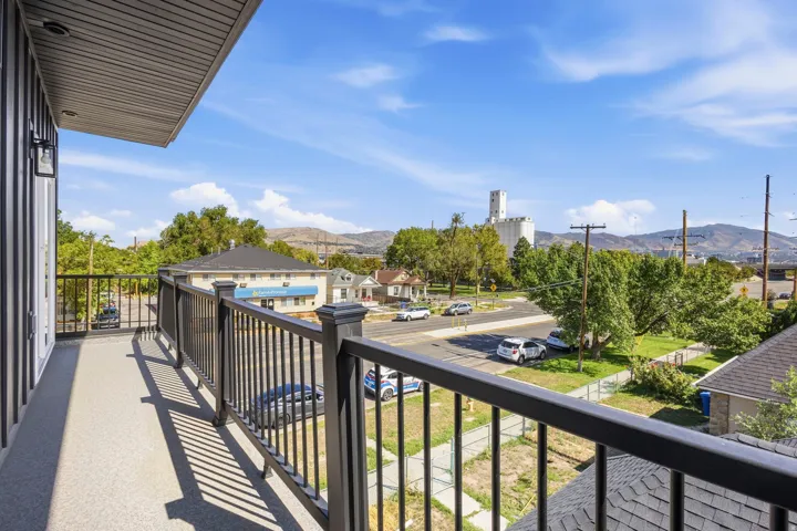 Balcony featuring a black metal railing and textured flooring