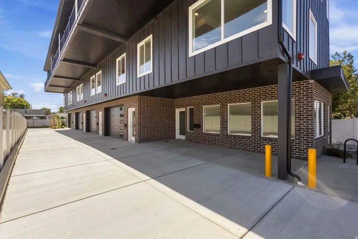 Modern exterior featuring dark vertical siding and dark brickwork