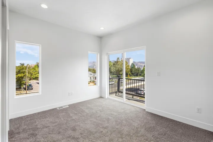 Recessed lighting, white walls, and gray carpeted flooring