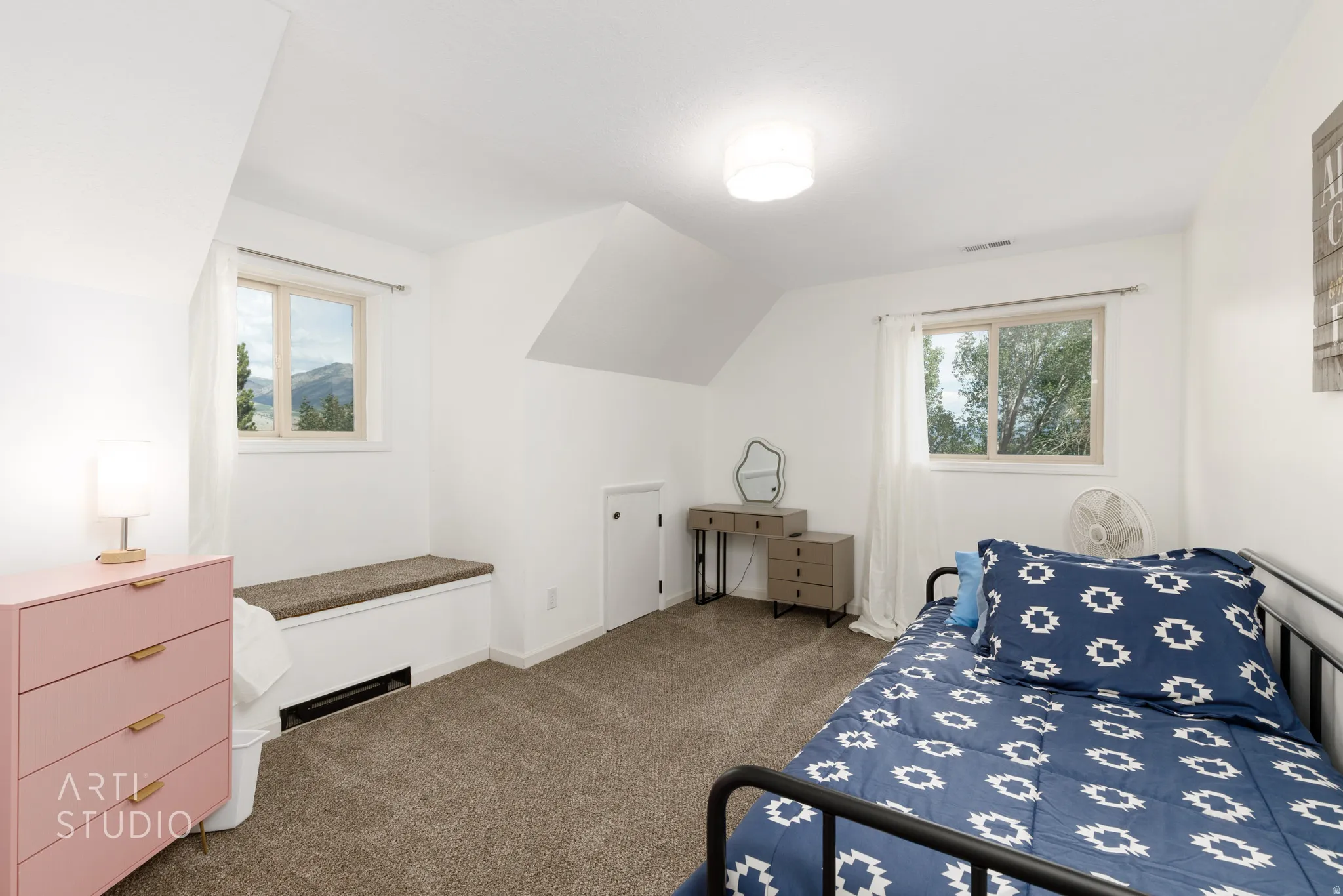 Plush carpet flooring, bright white walls, and a built-in window bench
