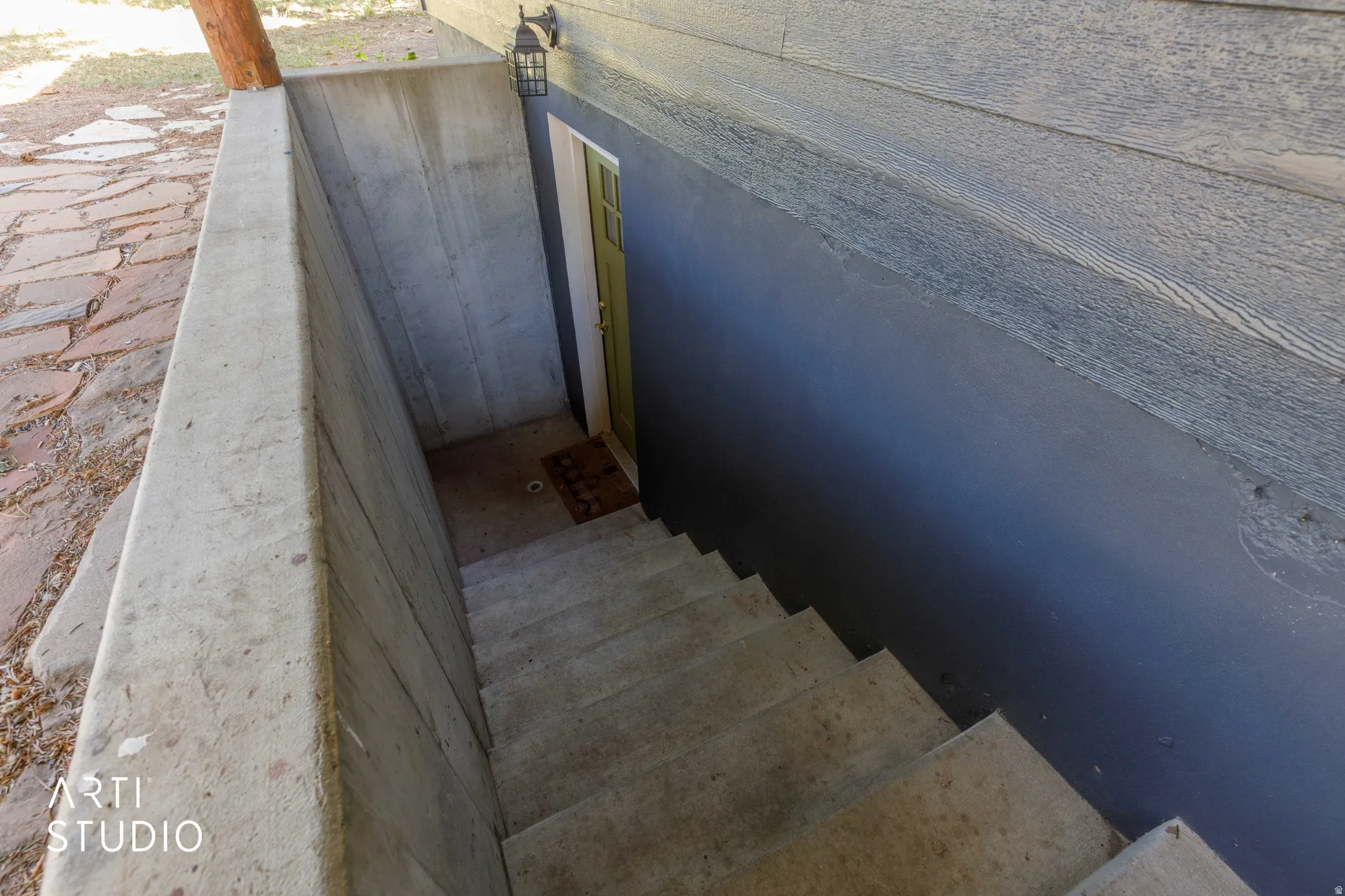 Concrete stairwell leading to a dedicated exterior entry