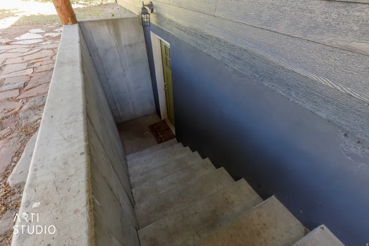 Concrete stairwell leading to a dedicated exterior entry