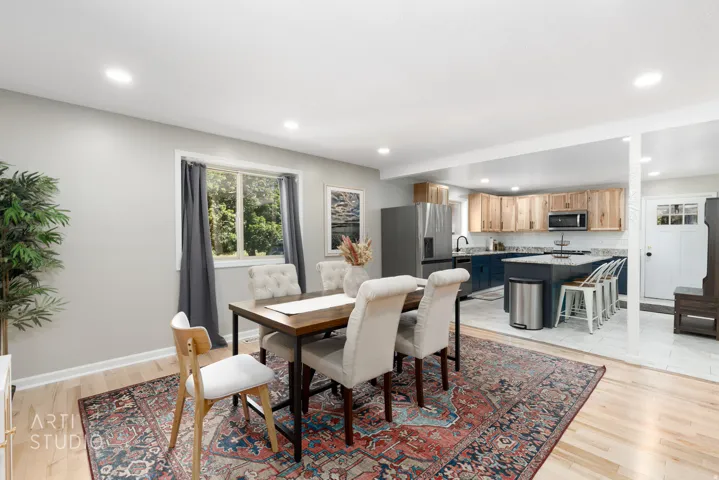 Open concept living area with light wood-finish flooring