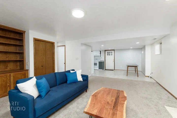 Built-in wood cabinetry, recessed ceiling lights, wall-to-wall carpeting, and tile flooring