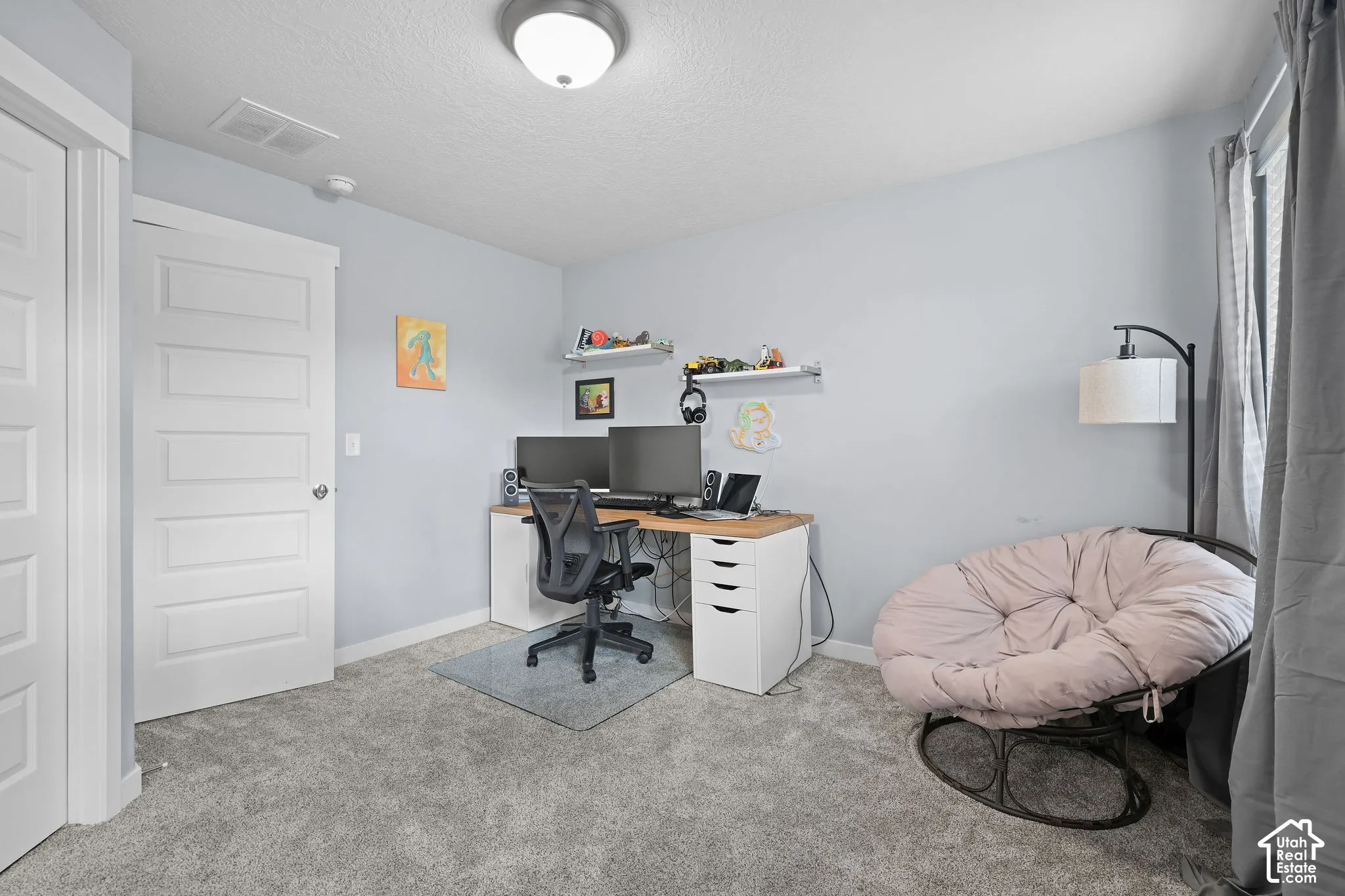 Recessed lighting, light gray wall paint, gray carpet flooring, white interior doors, and window with vertical blinds
