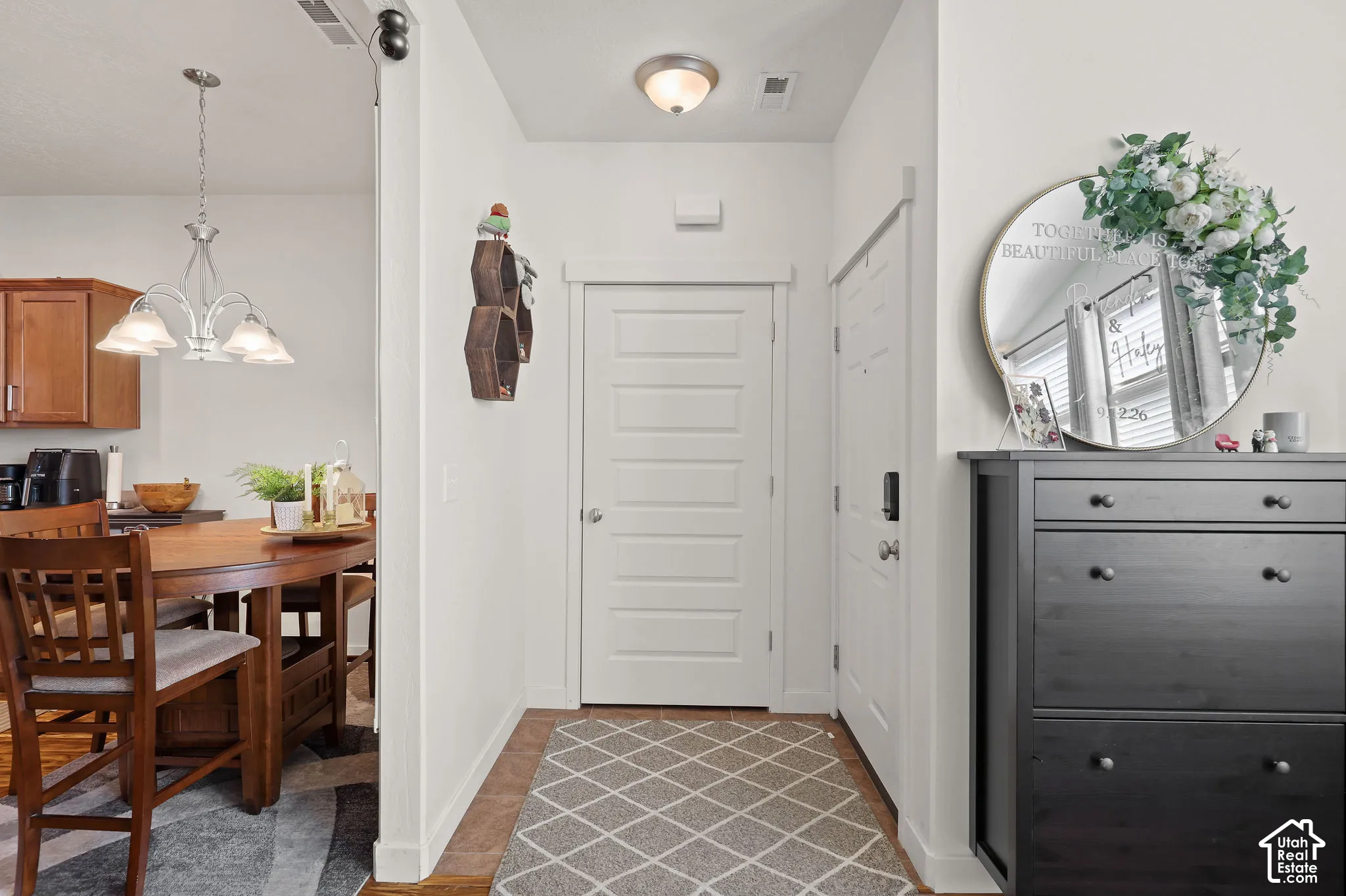 Entryway featuring a paneled door, flush-mount ceiling light, and wood-finish flooring