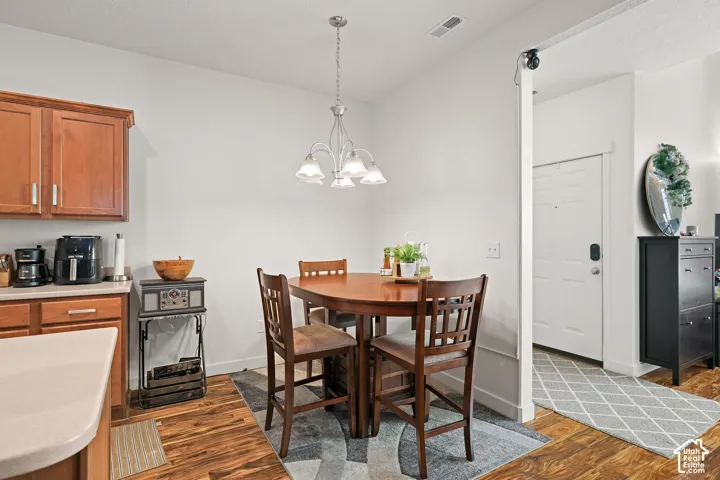 Wood-finish flooring throughout, complemented by a contemporary chandelier