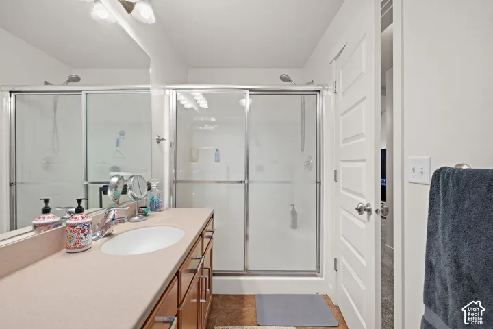 Vanity with an integrated sink, wood-finish cabinetry, and a full-width mirror