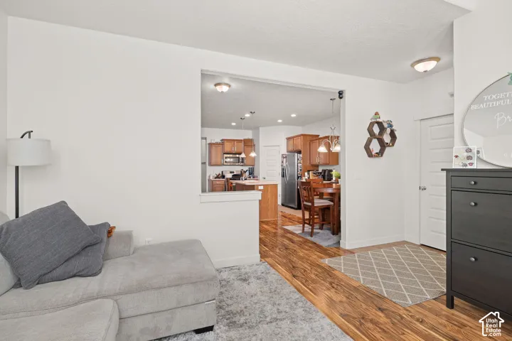 Wood-finish flooring throughout, with a clear sightline to the kitchen