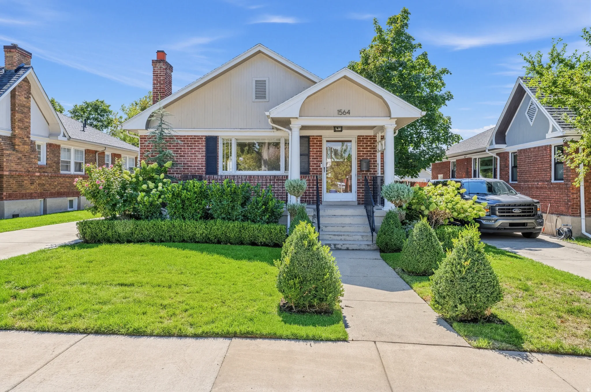Brick and siding exterior with a covered front porch and concrete steps