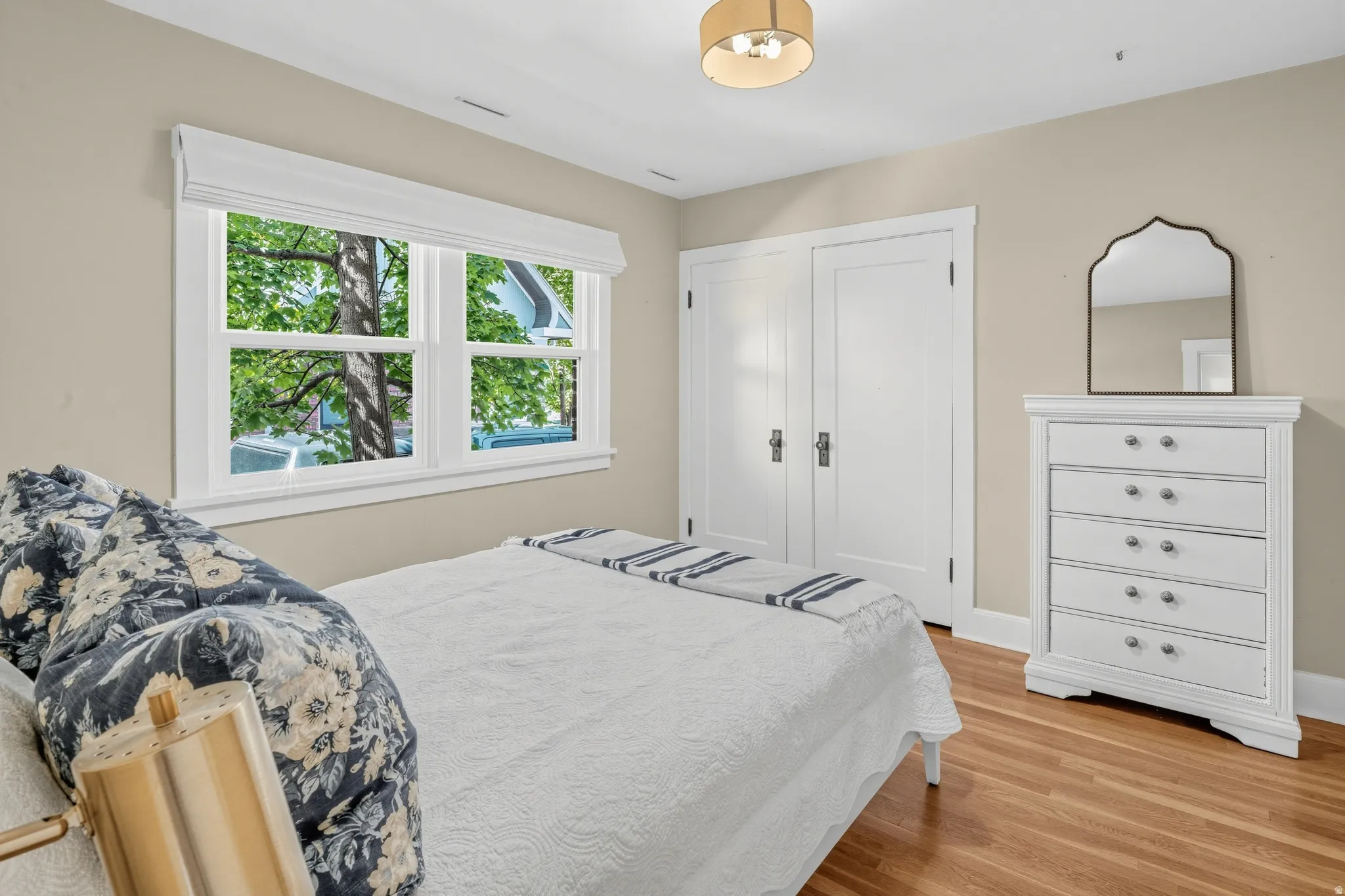 Hardwood flooring, double-hung windows, dual closet doors, and a flush mount ceiling fixture