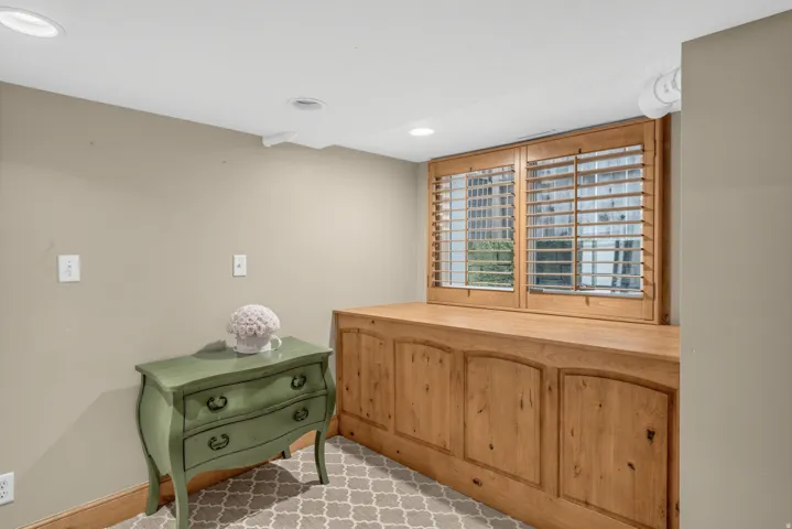 Built-in wood cabinetry with arch panel doors and a solid wood countertop