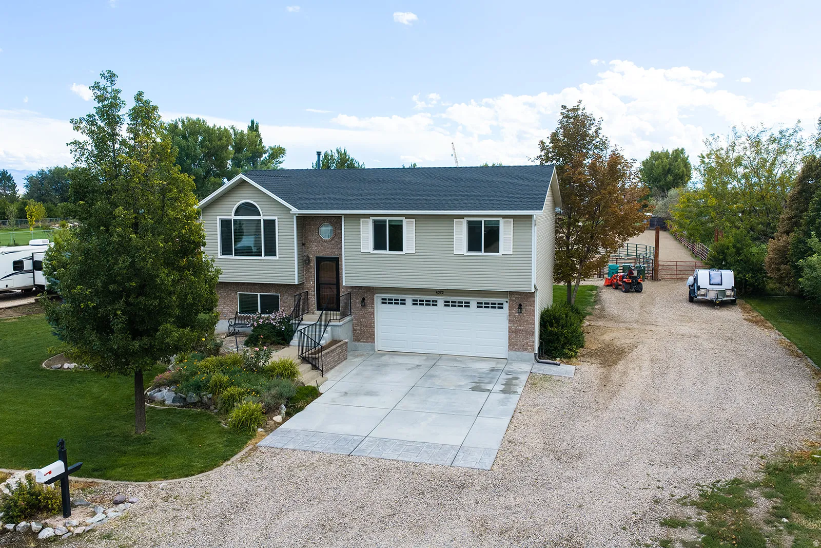 Two-story residence featuring brick and siding facade, an attached two-car garage, and a concrete driveway
