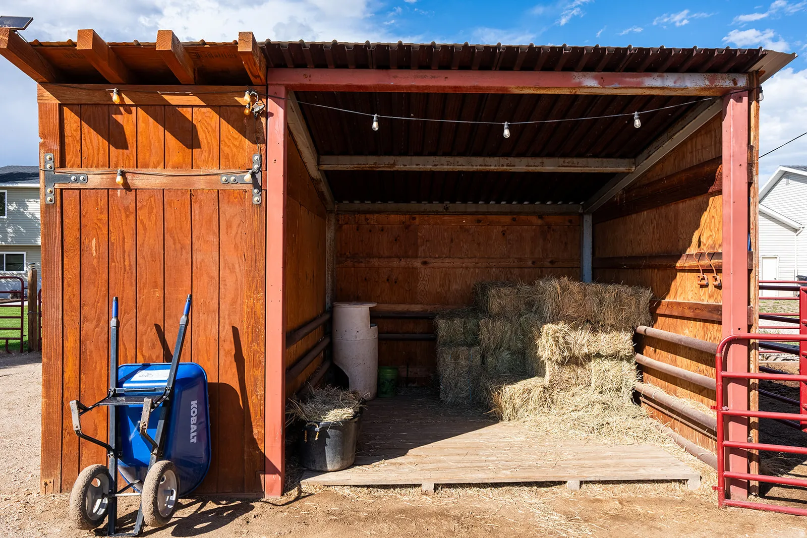 Wood-paneled outbuilding with a corrugated metal roof