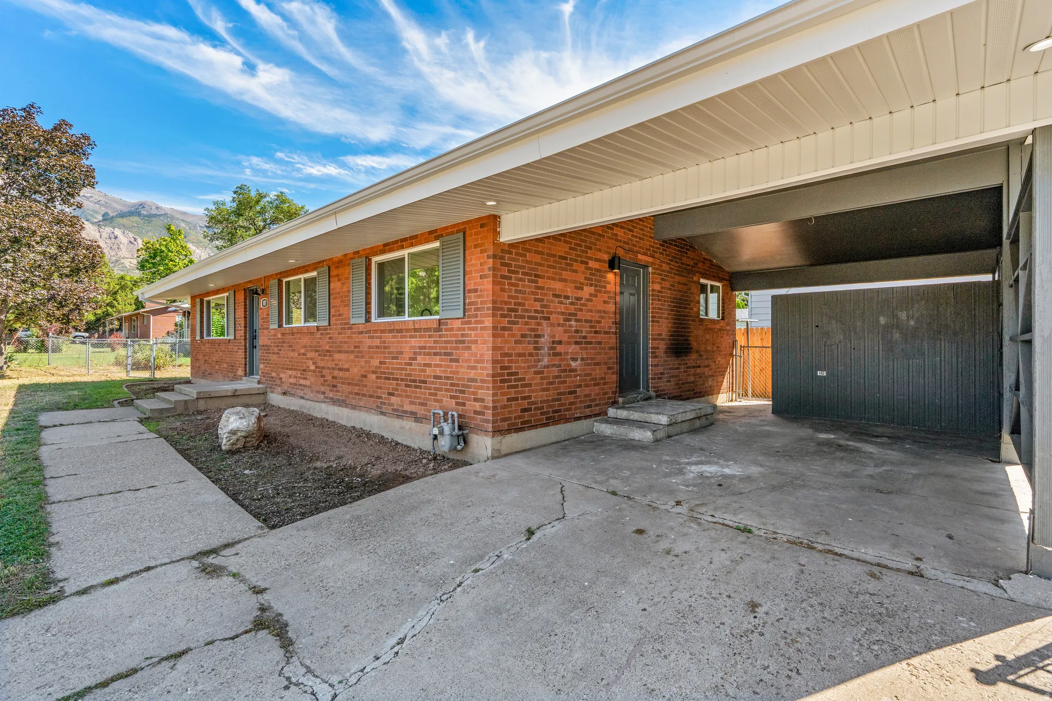 Brick exterior with a covered carport