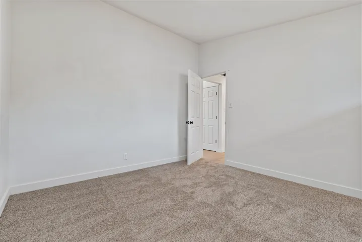 Neutral-toned carpeting and white walls