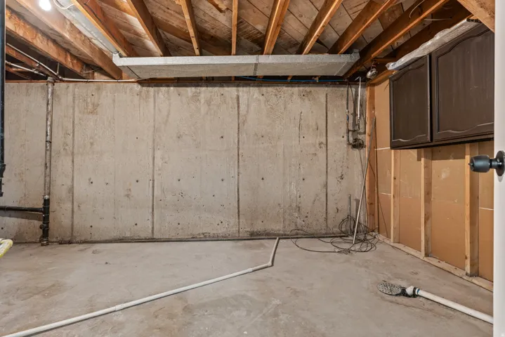 Concrete foundation walls with exposed wood ceiling joists
