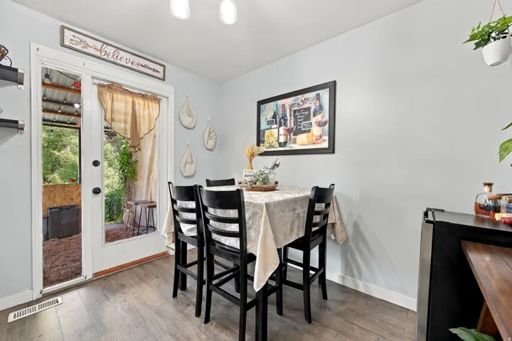 Wood-finish flooring with light gray walls and white trim
