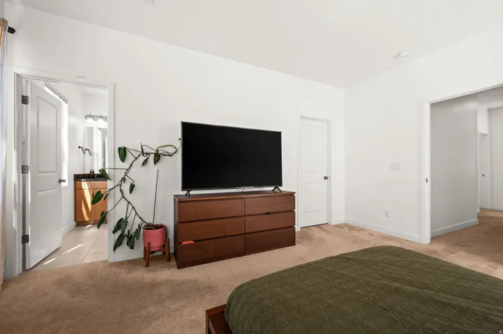 Neutral wall colors, carpeted flooring, and white trim