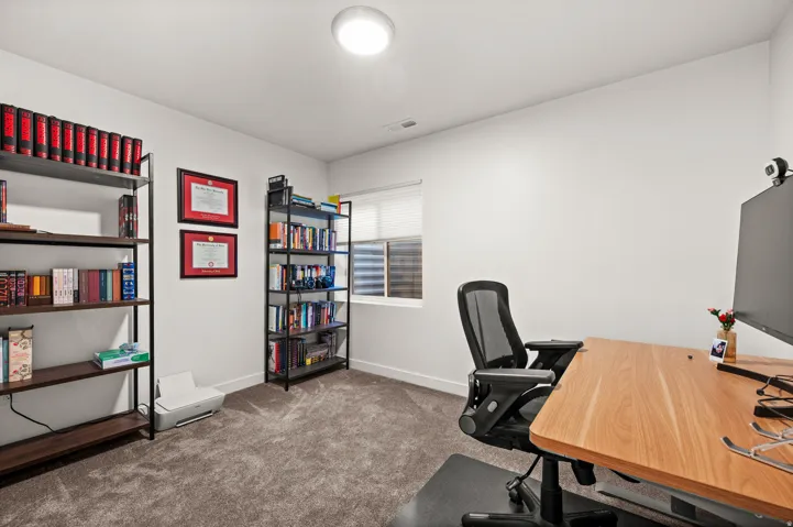 Neutral wall paint with carpet flooring, featuring a window with horizontal blinds and an overhead flush-mount light fixture