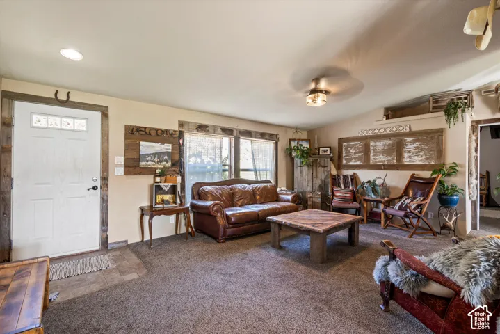 Recessed ceiling lighting, wood-finish door trim, light-colored walls, carpeted flooring, and a ceiling-mounted light fixture