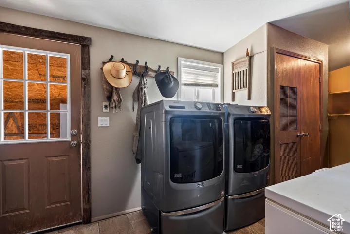 Full-size laundry appliances, wood-finish flooring, paneled interior door, and built-in shelving
