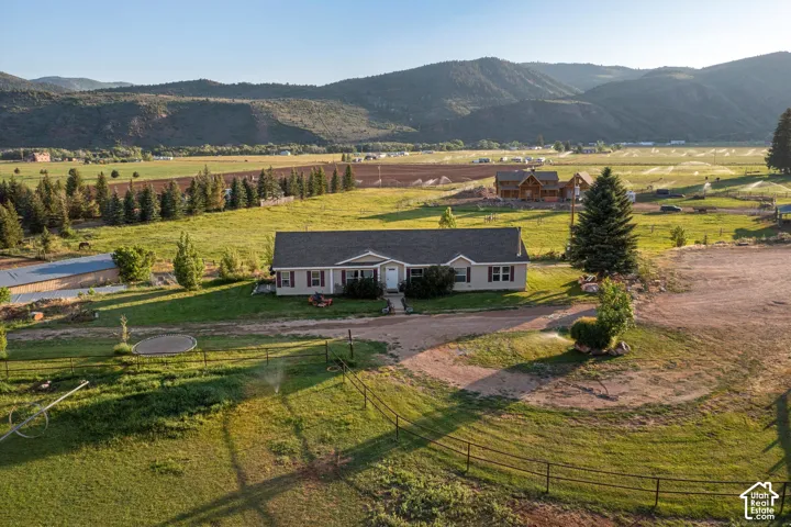 Ranch-style residence featuring a prominent front porch and dark gray shutters
