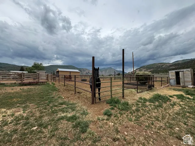 Extensive acreage featuring multiple fenced enclosures, a barn-style outbuilding, and a utility shed