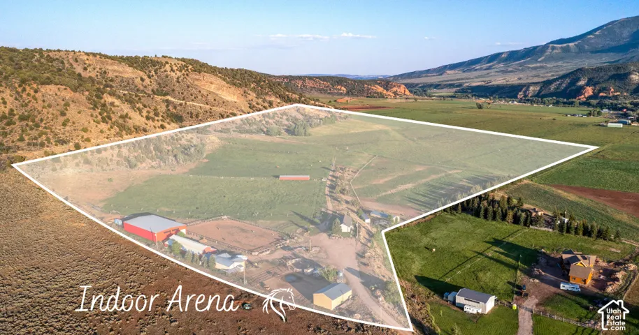 Expansive acreage featuring multiple structures, an indoor arena, and a large outdoor riding area