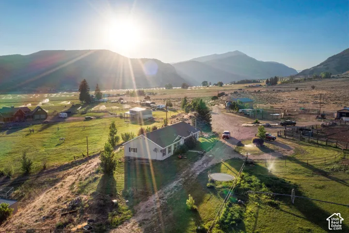 Property situated within a mountainous landscape featuring a gravel drive
