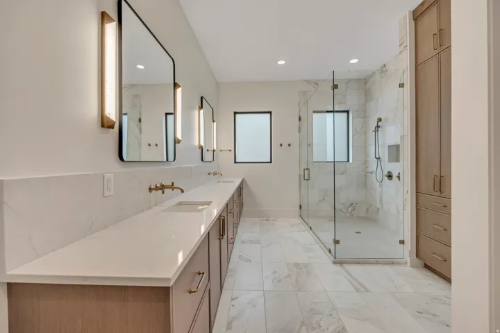 Dual vanity with wall-mounted faucets and integrated sinks