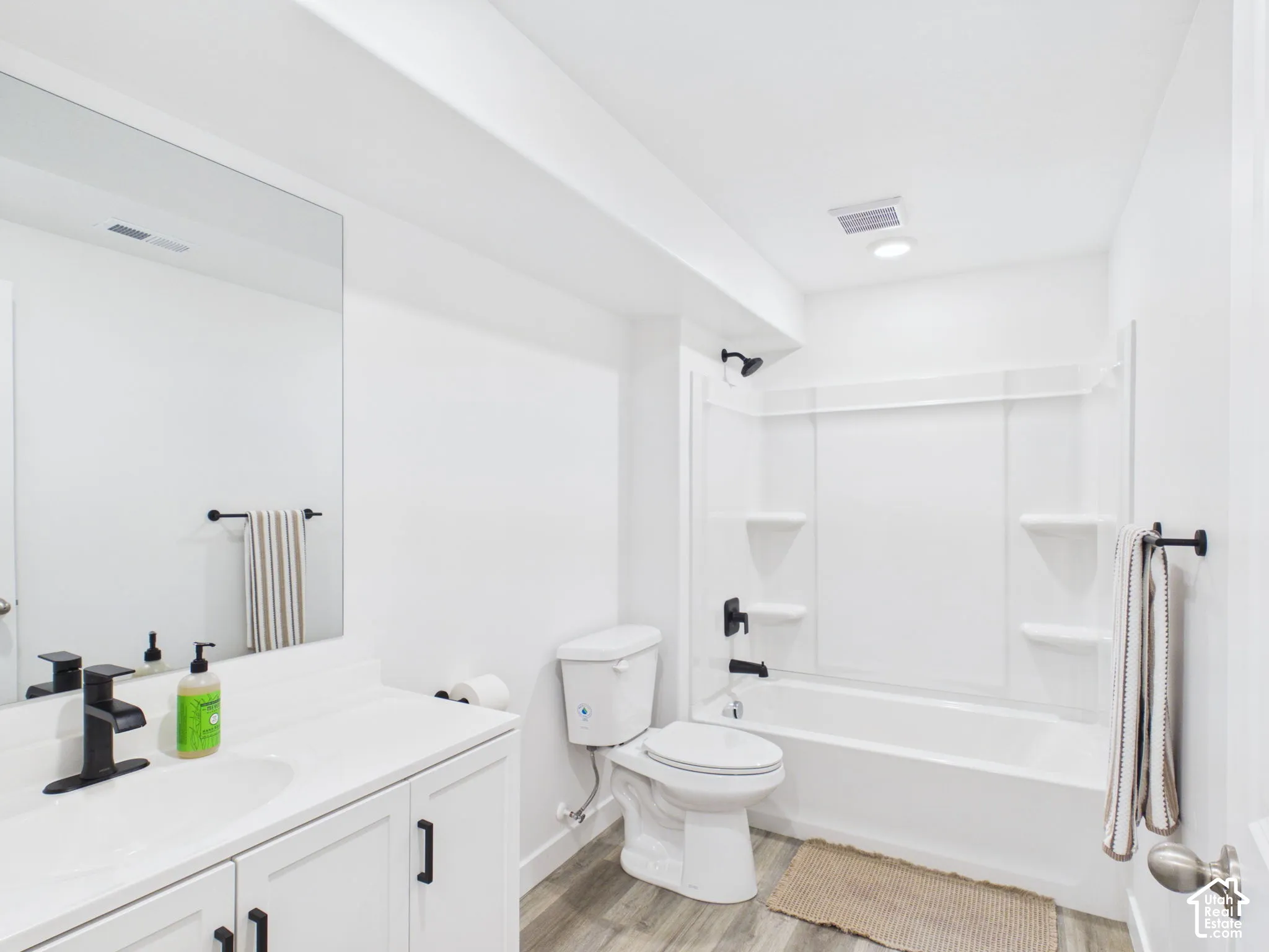 White vanity with integrated sink and matte black faucet