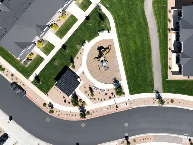 Community green space featuring a playground, paved walking paths, and landscaped common areas