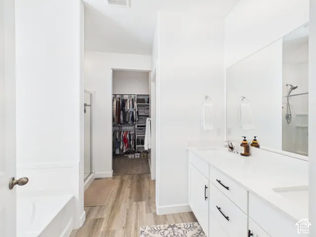 Dual white vanity with undermount sinks and dark hardware