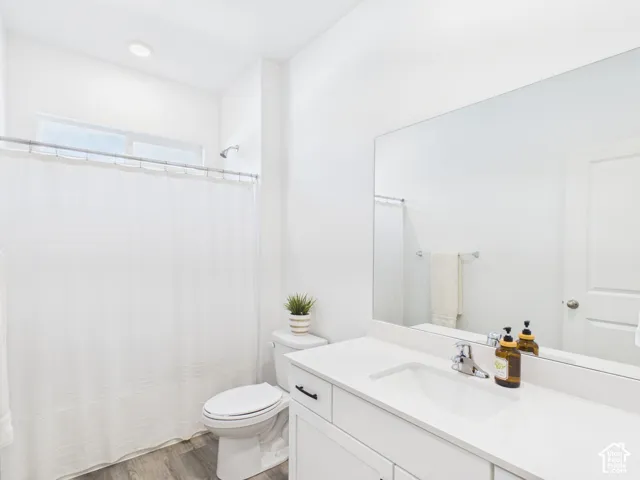 White vanity with an integrated sink, polished chrome faucet, and expansive mirror