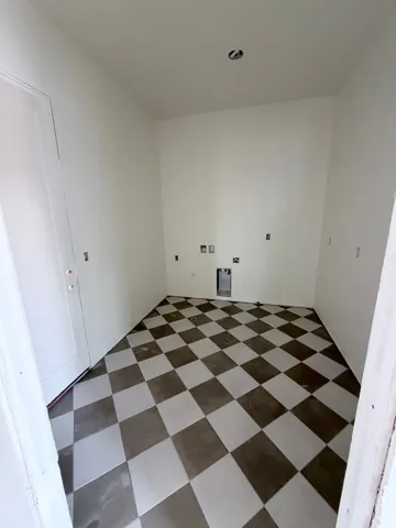 Chequered tile flooring, white walls, and a recessed ceiling light