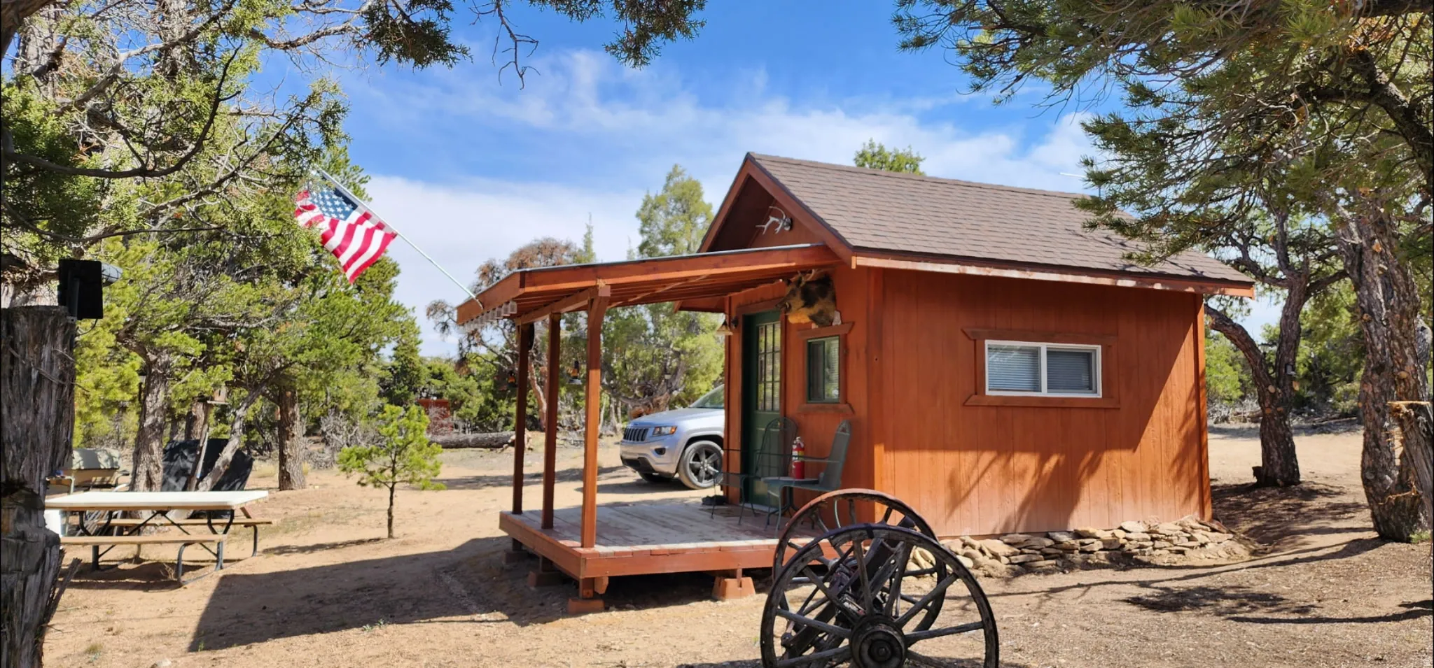 Wood-sided structure featuring a covered front porch and a gabled roof
