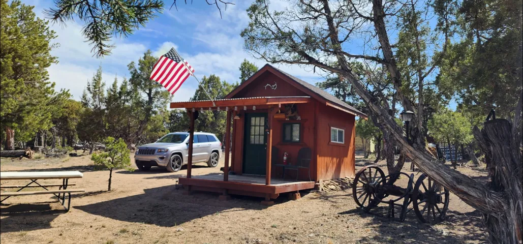 Freestanding structure with a covered porch, wood siding, and a metal roof