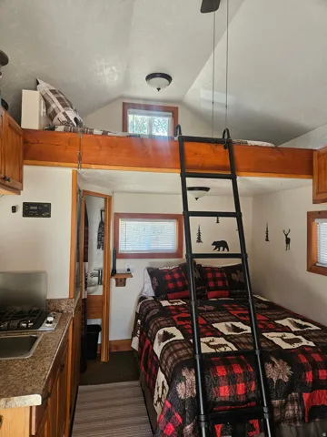 Compact living space featuring wood-finish cabinetry, a built-in gas cooktop, and a stainless steel sink
