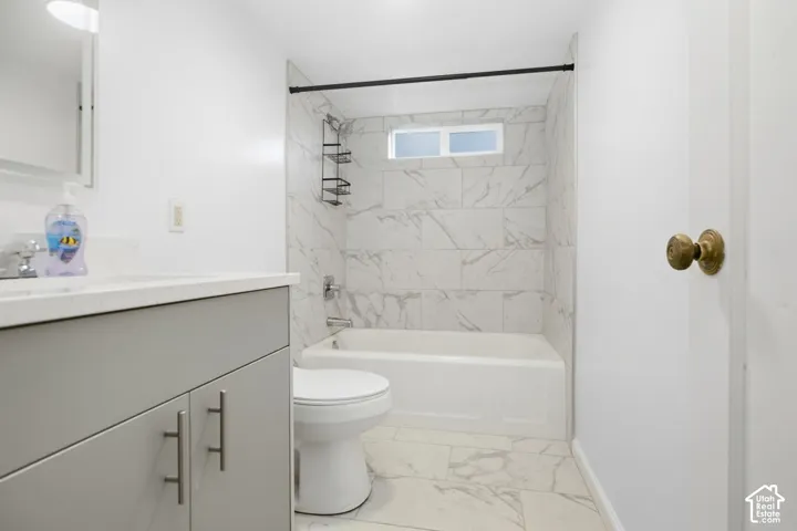 White tiled shower and bathtub combination with a window