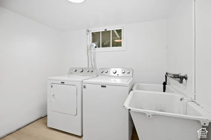 Laundry area with a utility sink and a window