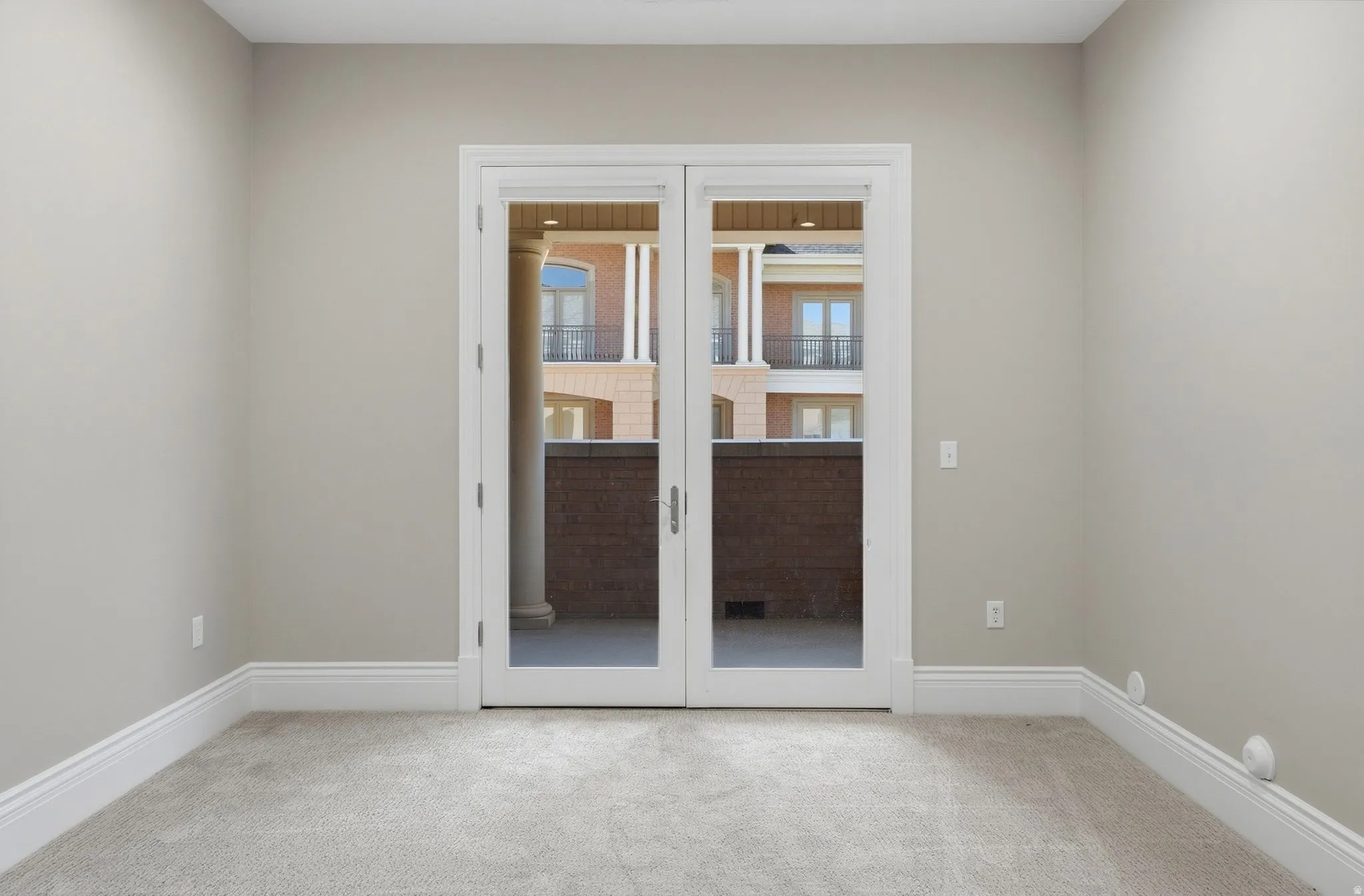 Double French doors leading to a private balcony